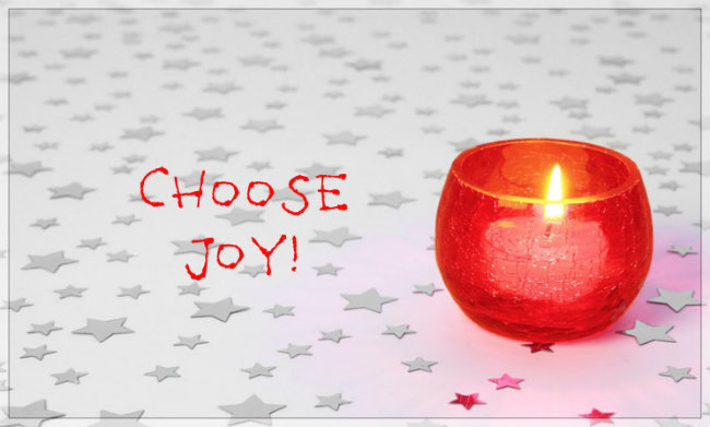 Choose Joy! In playful letters on simple poster of a red lit candle 